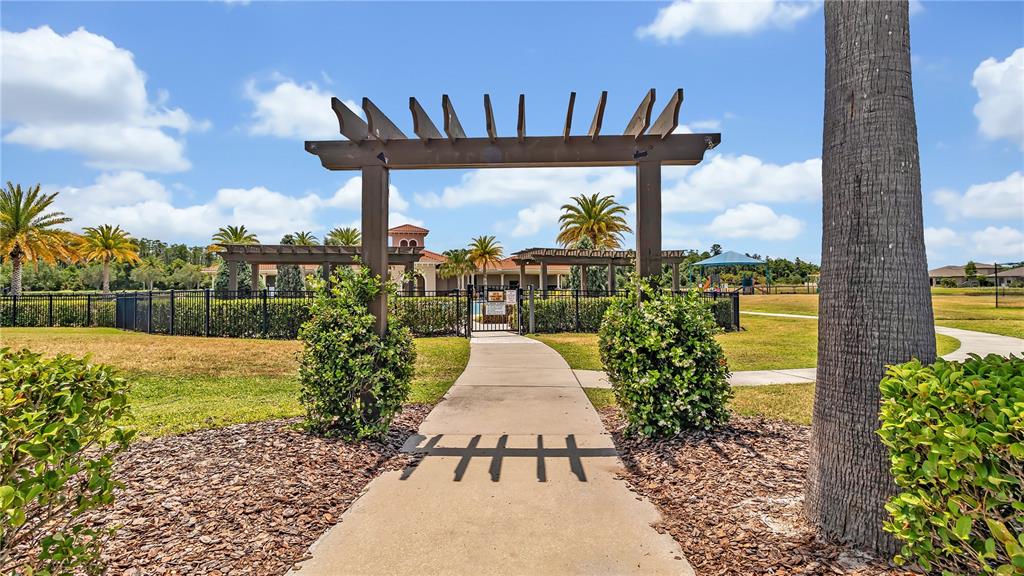 16669 Windmill Forge Pass Wimauma, FL 33598 - Photo 36 of 44 a view of a swimming pool with a bench and a porch