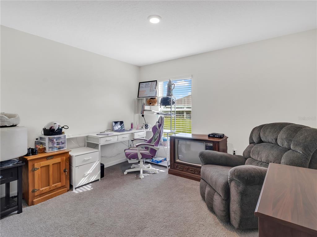 16669 Windmill Forge Pass Wimauma, FL 33598 - Photo 6 of 44 a living room with furniture and a wooden floor