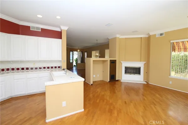 a view of kitchen with cabinets and refrigerator