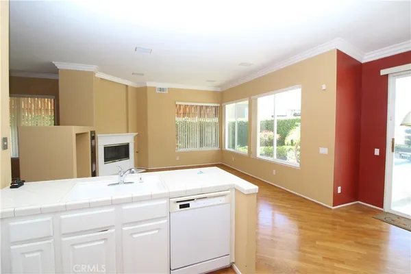 a bathroom with a sink and a large mirror next to a window