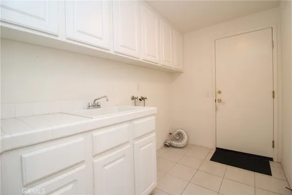 a utility room with sink dryer and washer