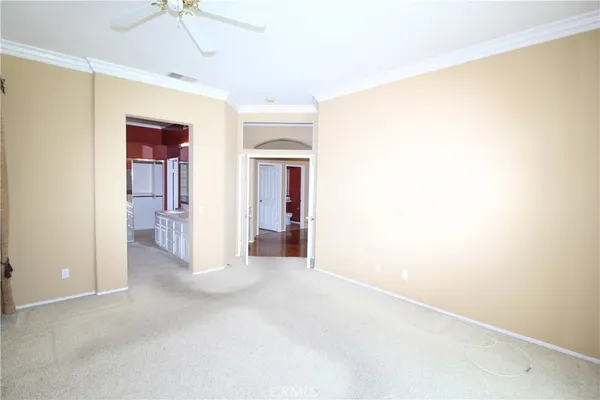a view of a big room with closet and chandelier fan