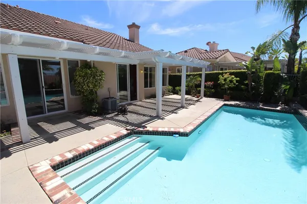 a view of a patio with swimming pool