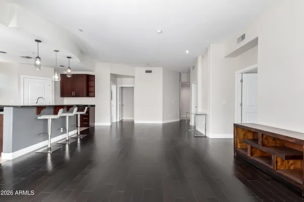 a view of a kitchen with a stove wooden cabinets and a refrigerator