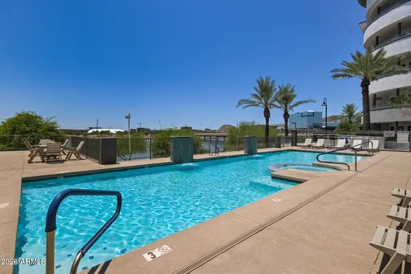 a view of a swimming pool and lounge chairs