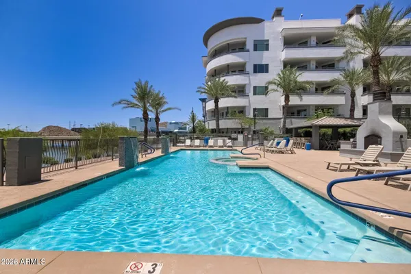 a swimming pool with outdoor seating and yard