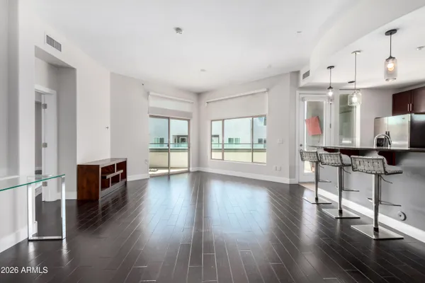 a view of a living room and dining room with wooden floor