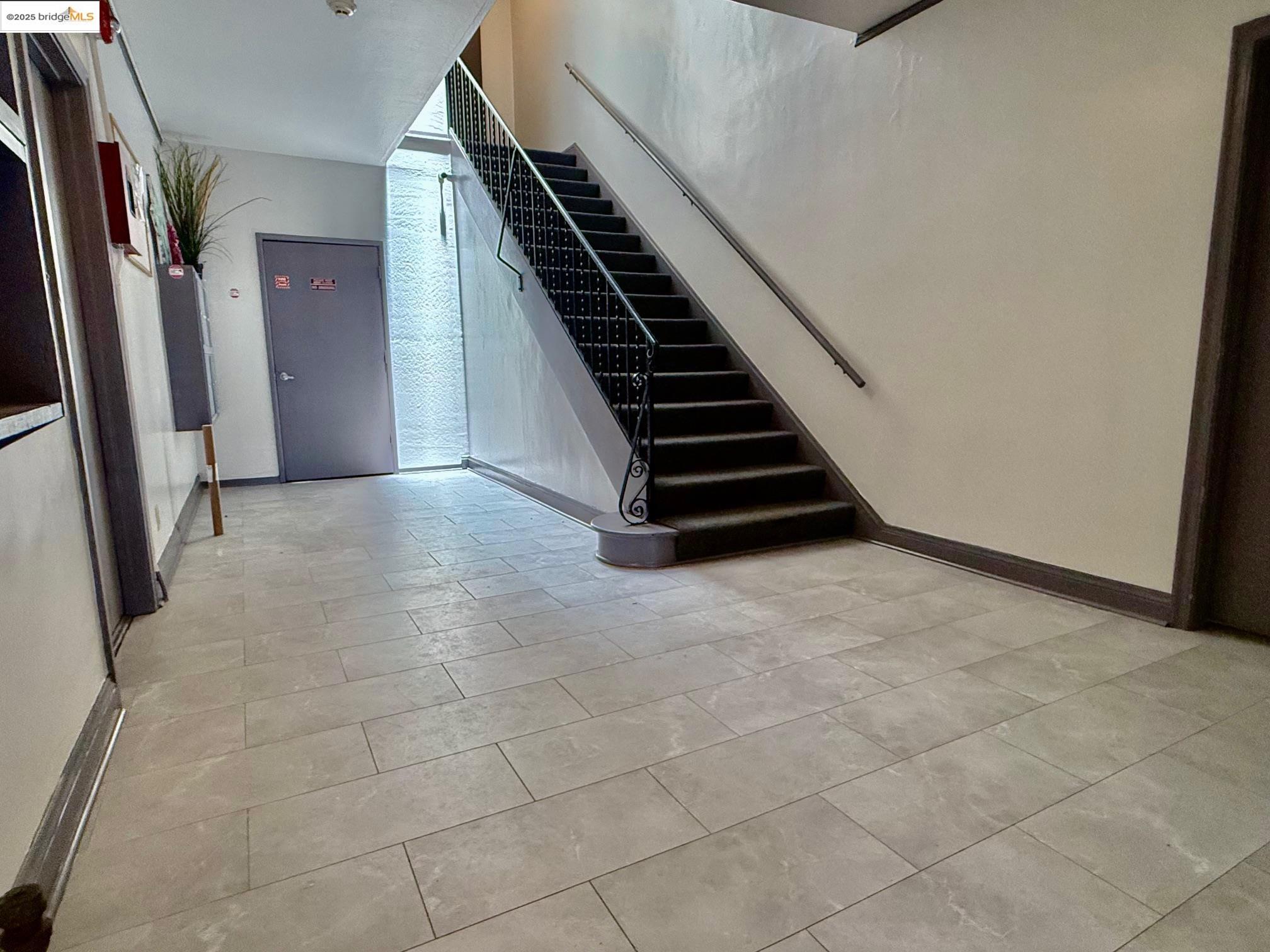 2240 MacArthur Boulevard Oakland, CA 94602 - Photo 11 of 13 Stairway featuring baseboards and tile patterned flooring