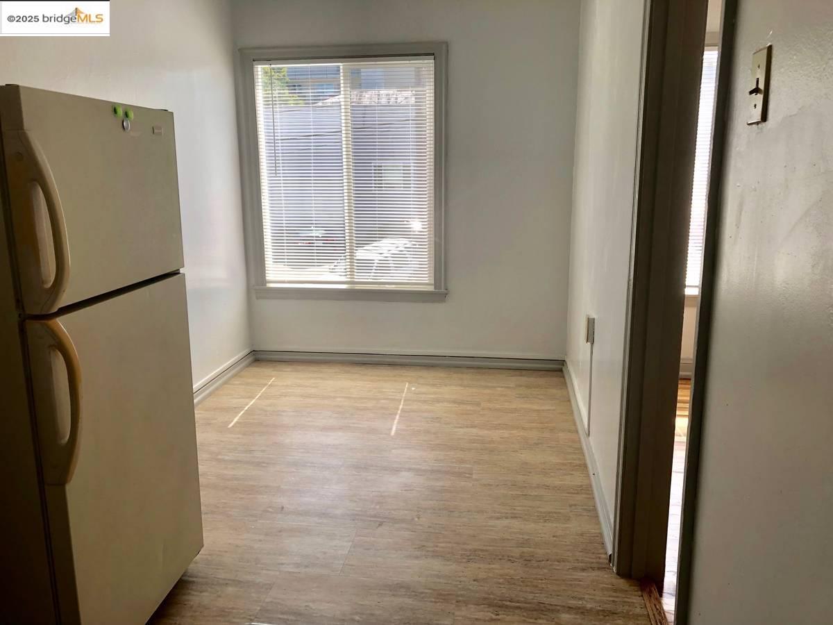 2240 MacArthur Boulevard Oakland, CA 94602 - Photo 3 of 13 Unfurnished dining area with wood finished floors and baseboards