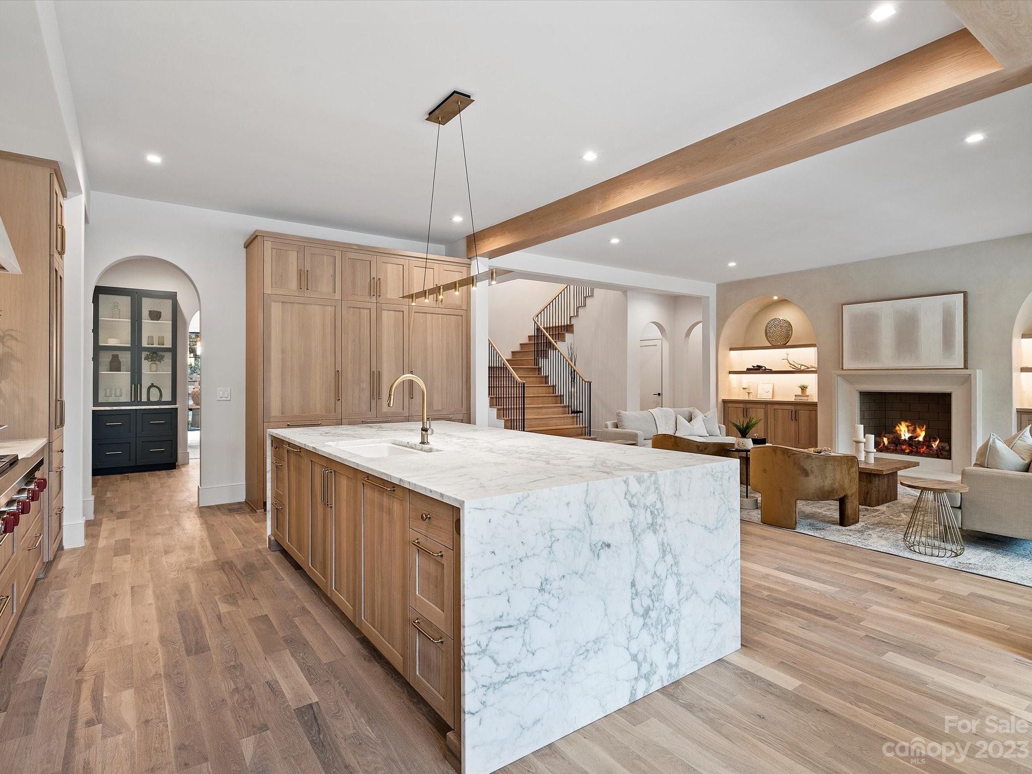 3272 Foxcroft Road Charlotte, NC 28211 - Photo 6 of 42 a large kitchen with kitchen island a stove a sink dishwasher a refrigerator and wooden floor