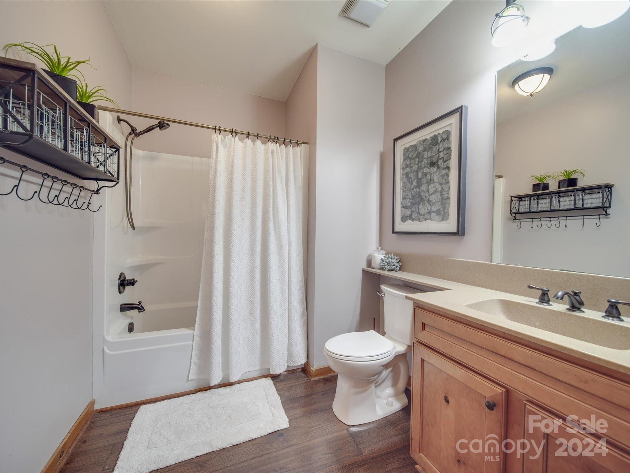 1220 Bridges Acres Road Kannapolis, NC 28083 - Photo 16 of 46 a bathroom with a sink a toilet and shower curtain