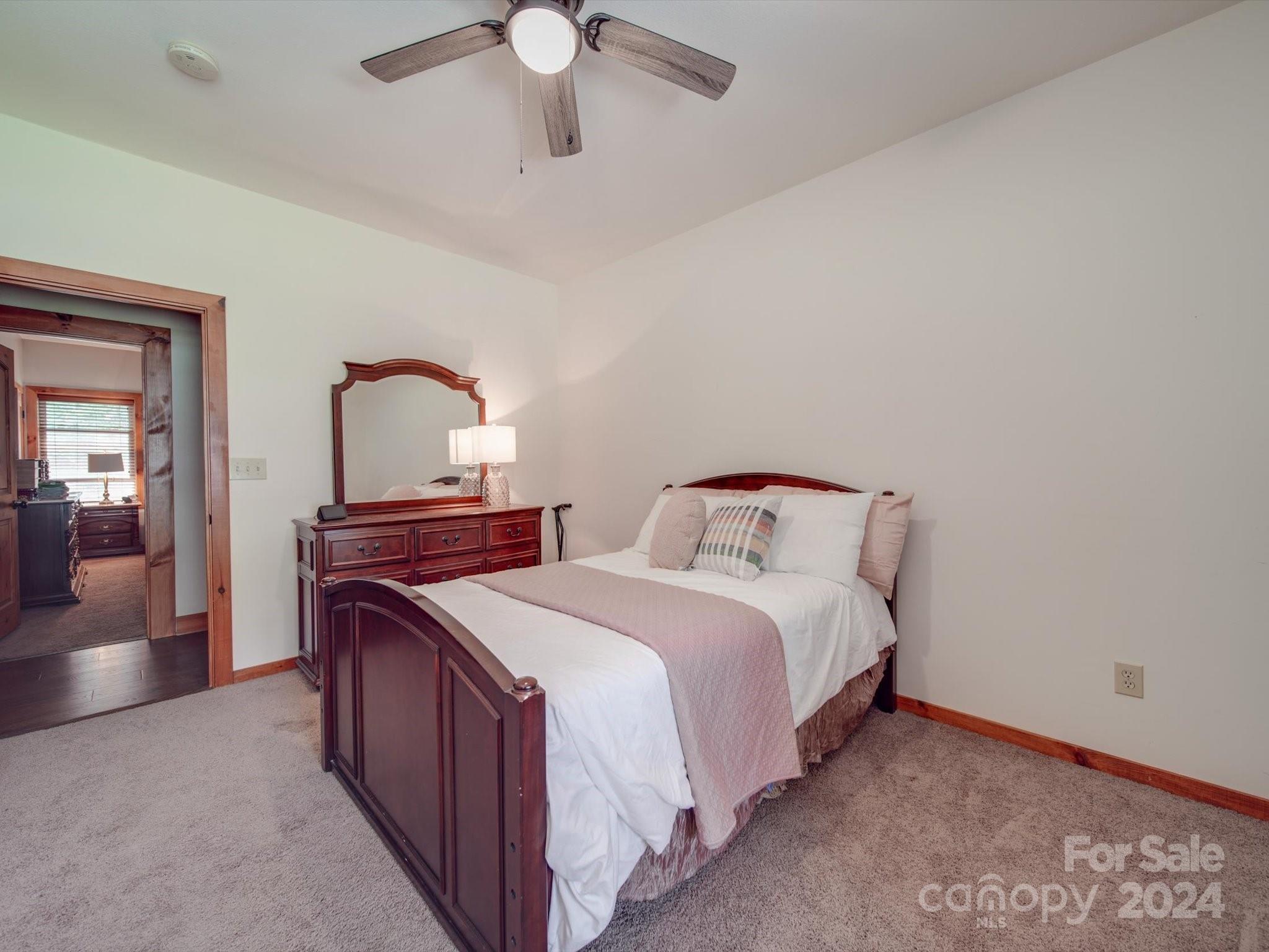 1220 Bridges Acres Road Kannapolis, NC 28083 - Photo 29 of 46 a spacious bedroom with two beds and a chandelier