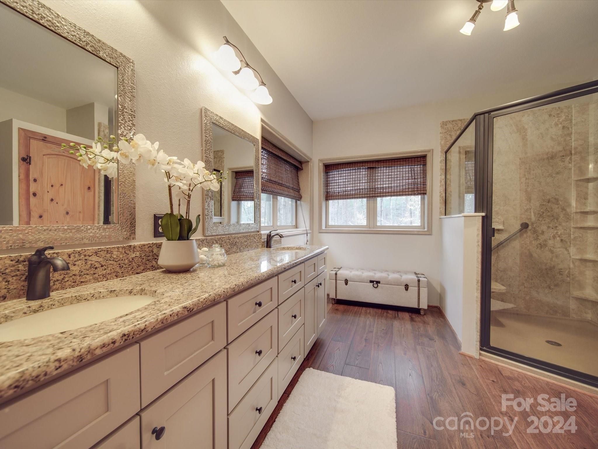 1220 Bridges Acres Road Kannapolis, NC 28083 - Photo 36 of 46 a bathroom with a granite countertop double vanity sink a mirror and a shower