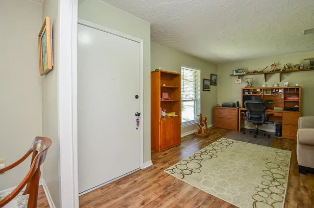 a view of a bedroom with workspace and bedroom