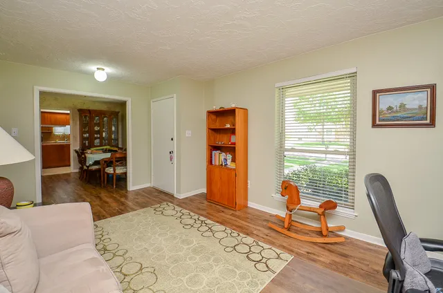 a living room with furniture a window and a flat screen tv