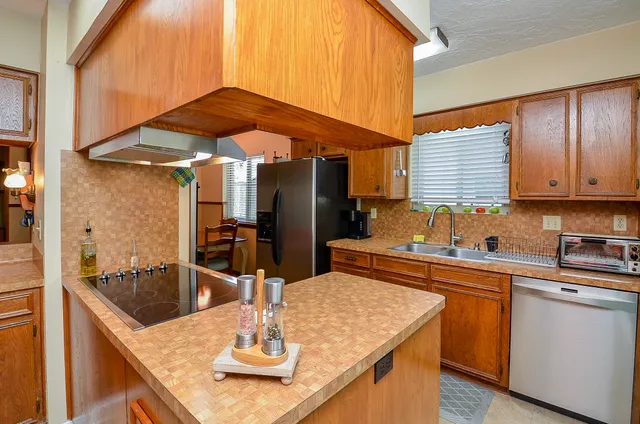 a kitchen with stainless steel appliances granite countertop a sink and cabinets
