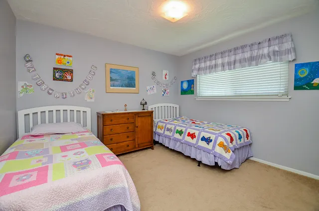 a bedroom with a bed and a dresser in it