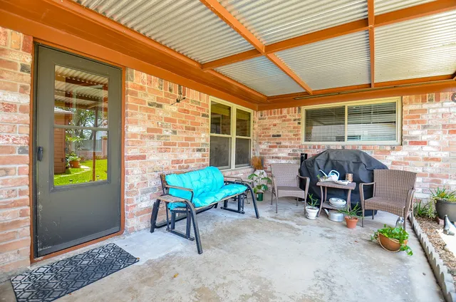 a balcony with furniture and garden view