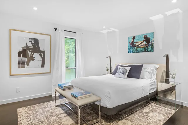 a bedroom with a bed and a painting on the wall