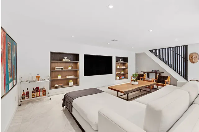 a bedroom with two beds and a flat screen tv