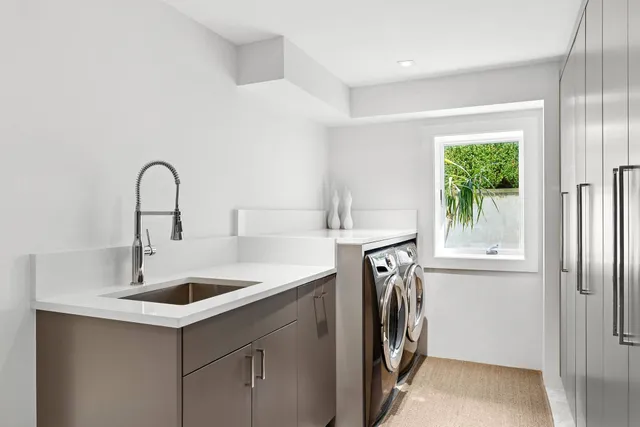 a view of a sink and a washer in a room