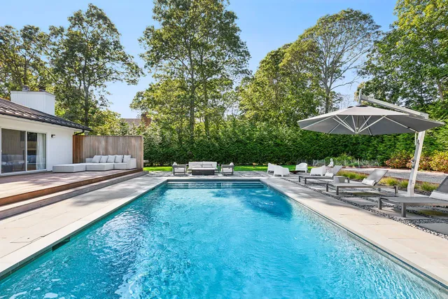 a view of swimming pool with sitting area and furniture