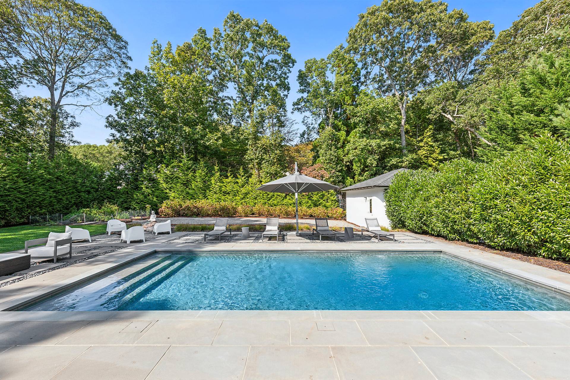 8 Patriots Lane East Hampton, NY 11937 - Photo 2 of 23 a view of a yard with table and chairs
