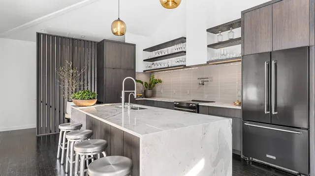 a kitchen with stainless steel appliances a sink and a refrigerator