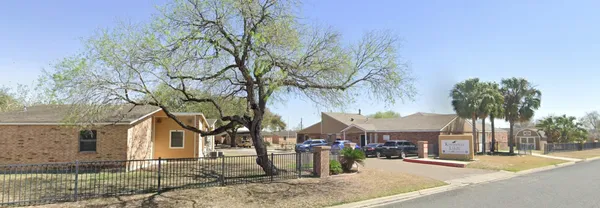 front view of a house with a tree