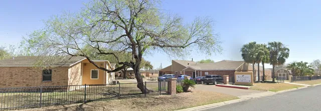 front view of a house with a tree