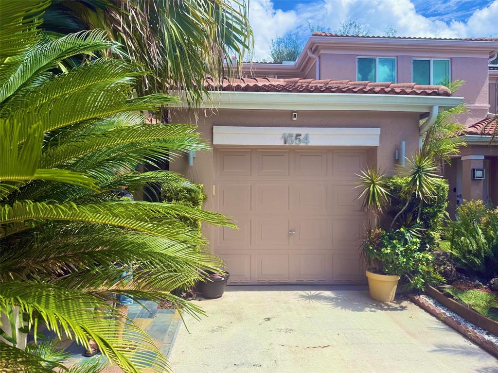 1654 Southwest 109th Terrace Davie, FL 33324 - Photo 1 of 24 a front view of a house with plants