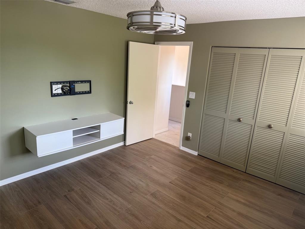 1654 Southwest 109th Terrace Davie, FL 33324 - Photo 11 of 24 a view of a livingroom with wooden floor and chandelier