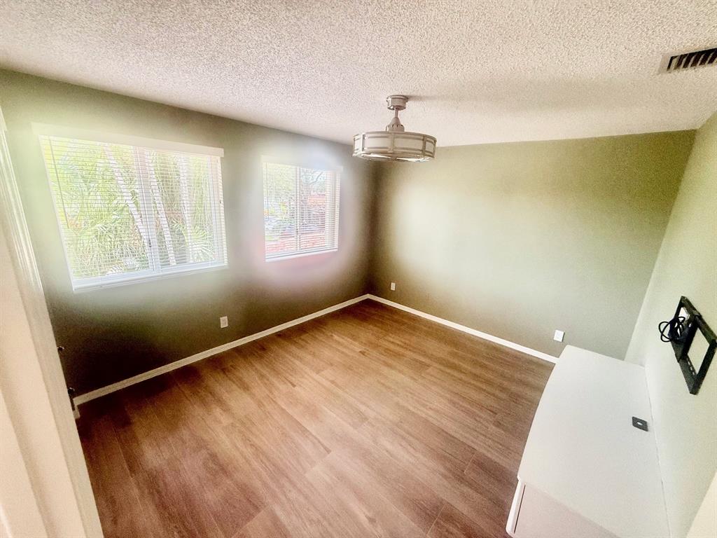 1654 Southwest 109th Terrace Davie, FL 33324 - Photo 12 of 24 wooden floor in an empty room with a window