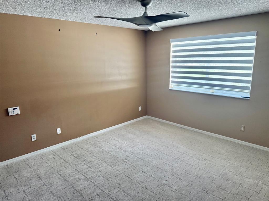 1654 Southwest 109th Terrace Davie, FL 33324 - Photo 14 of 24 a view of empty room with windows and ceiling fan