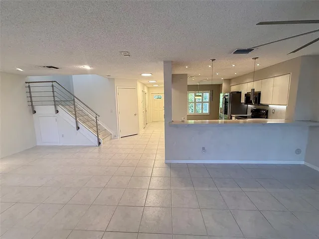 a view of a kitchen with a sink and cabinets