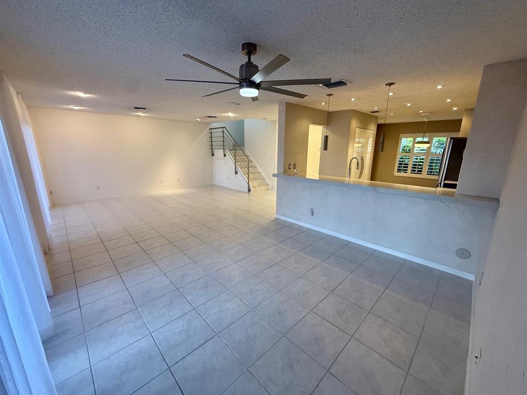 1654 Southwest 109th Terrace Davie, FL 33324 - Photo 5 of 24 a view of a livingroom with a ceiling fan and window