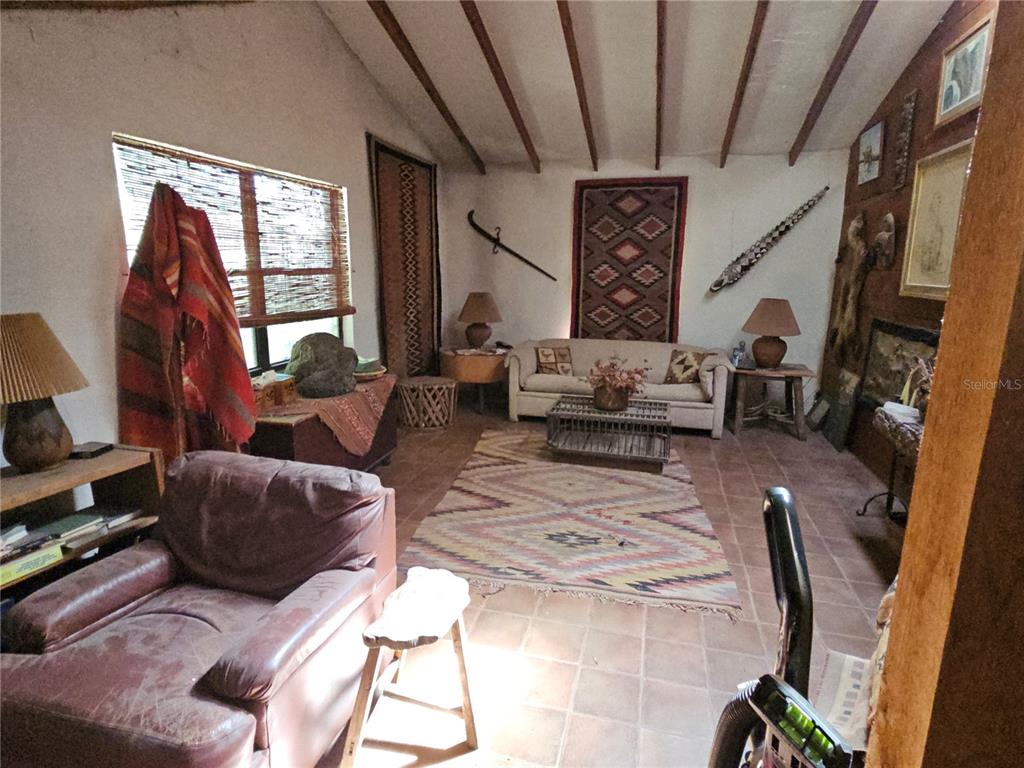 10679 Goose Prairie Road Leesburg, FL 34788 - Photo 12 of 30 a living room with furniture and a flat screen tv
