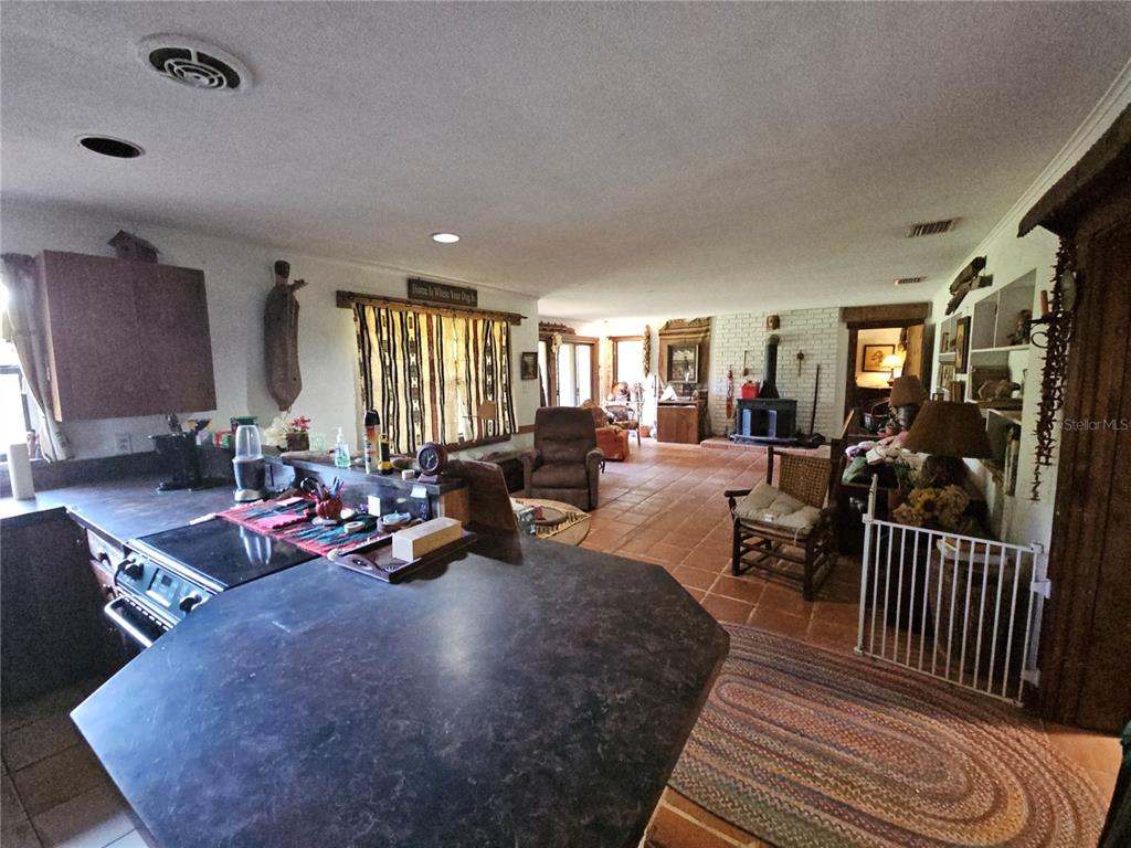 10679 Goose Prairie Road Leesburg, FL 34788 - Photo 15 of 30 a living room with furniture a window and gym equipment
