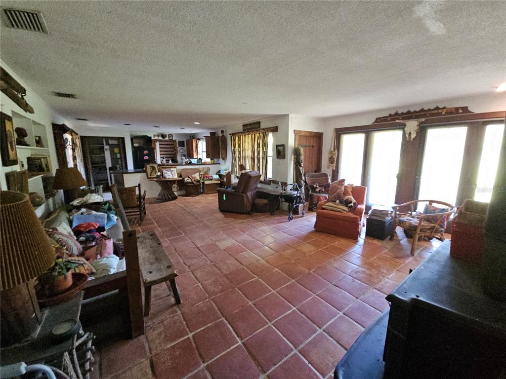10679 Goose Prairie Road Leesburg, FL 34788 - Photo 17 of 30 a living room with furniture and a large window