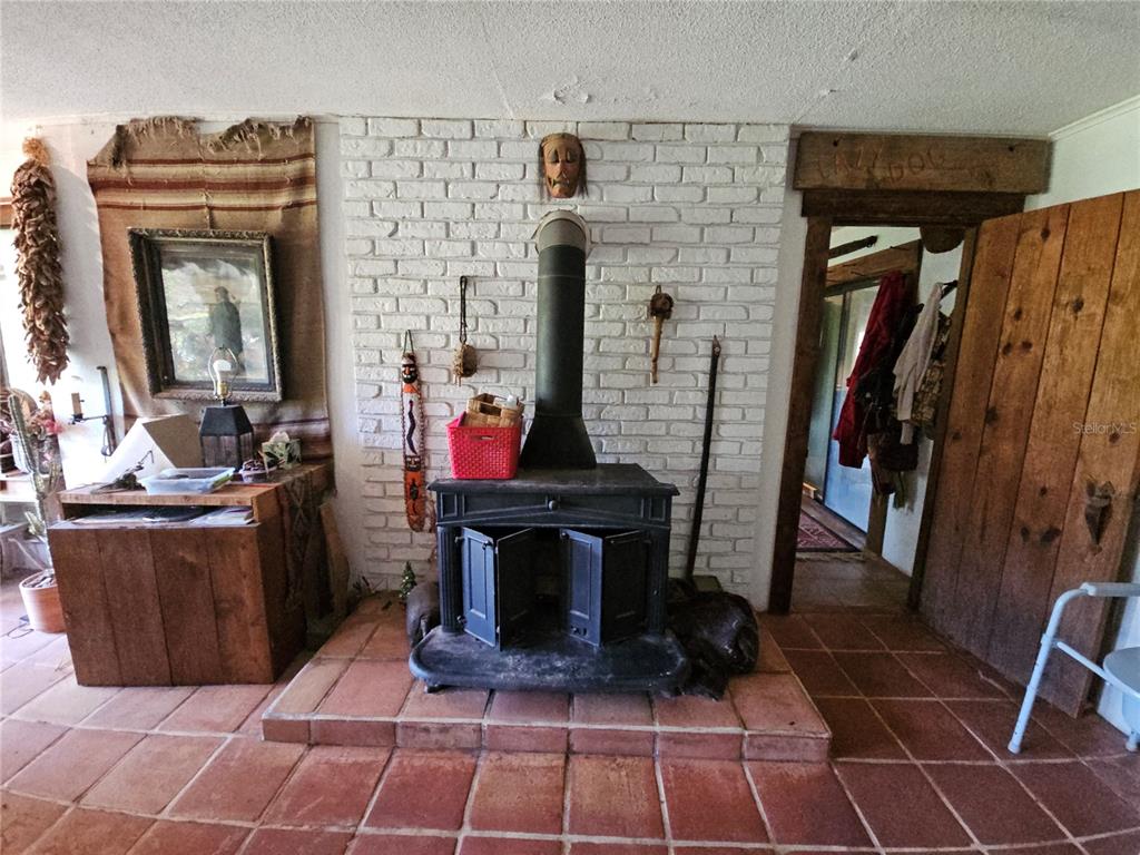 10679 Goose Prairie Road Leesburg, FL 34788 - Photo 18 of 30 a living room with washing machine and a fireplace