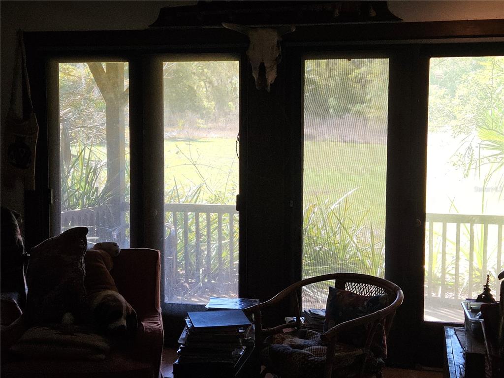 10679 Goose Prairie Road Leesburg, FL 34788 - Photo 19 of 30 a living room with furniture and large windows