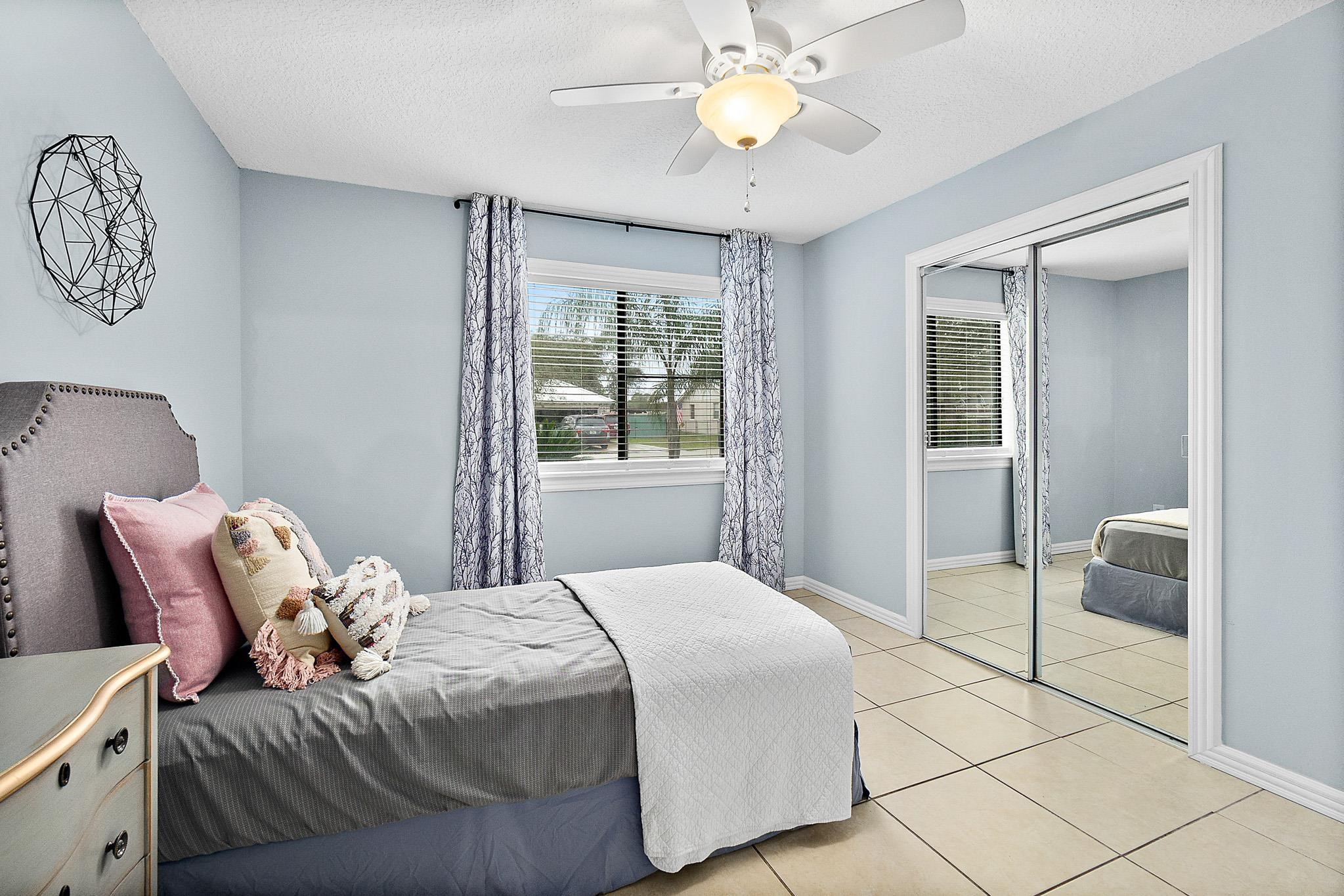 133 Gentian Road St. Augustine, FL 32086 - Photo 31 of 40 a bedroom with a bed and a chandelier