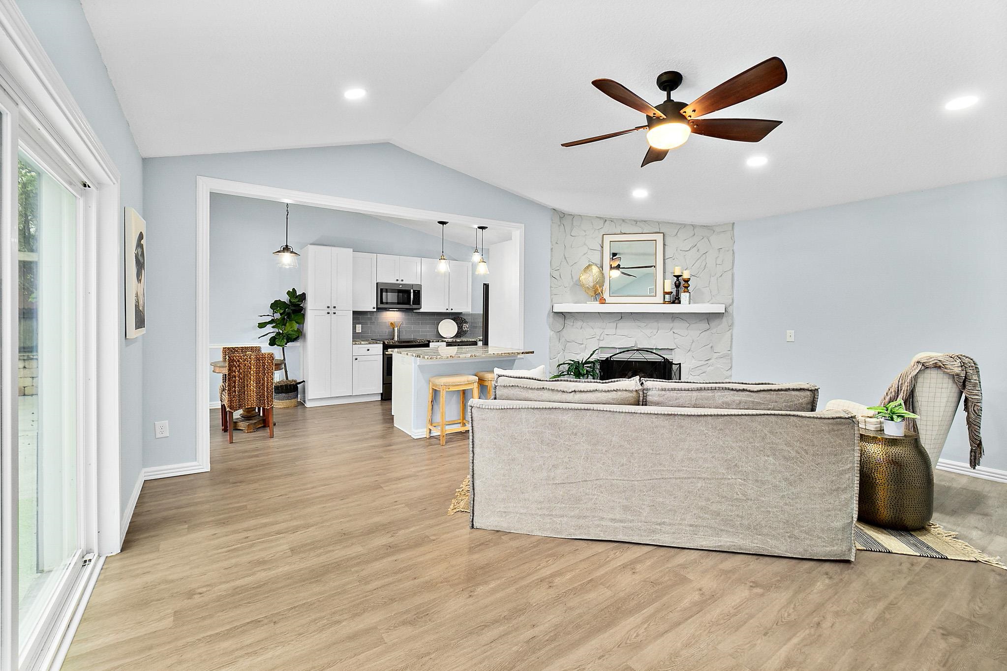 133 Gentian Road St. Augustine, FL 32086 - Photo 10 of 40 a living room with stainless steel appliances kitchen island furniture and a chandelier