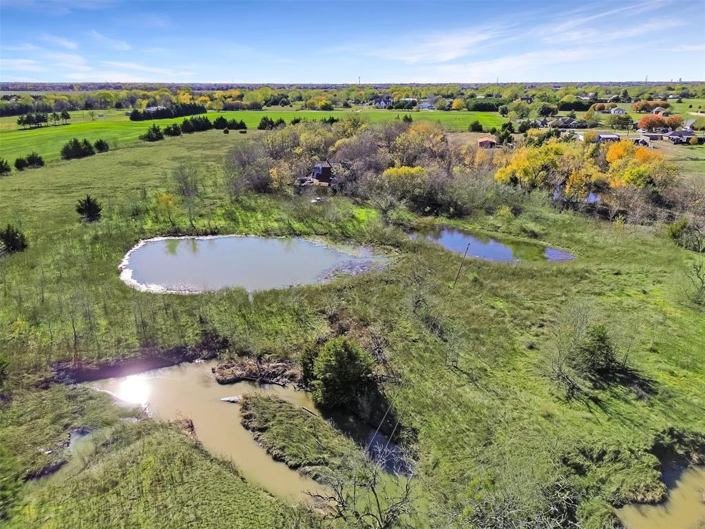 1851 Stainback Road Ferris, TX 75125 - Photo 7 of 8 an aerial view of a house with a yard and lake view