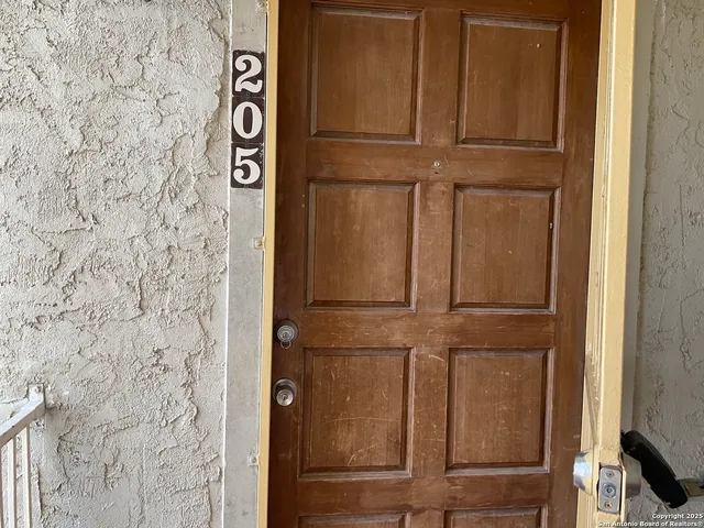 a view of an entryway with wooden floor