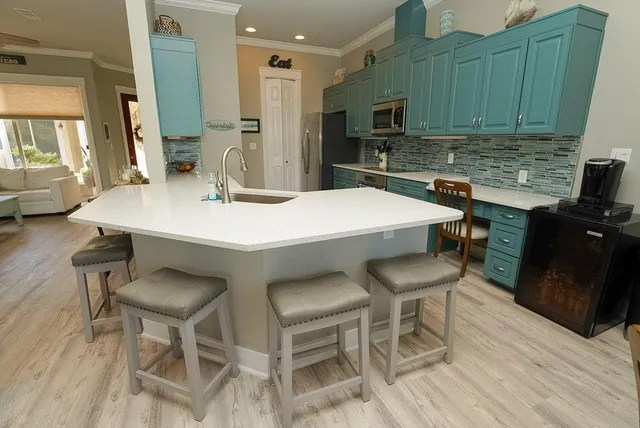 a dining room with furniture a chandelier and wooden floor