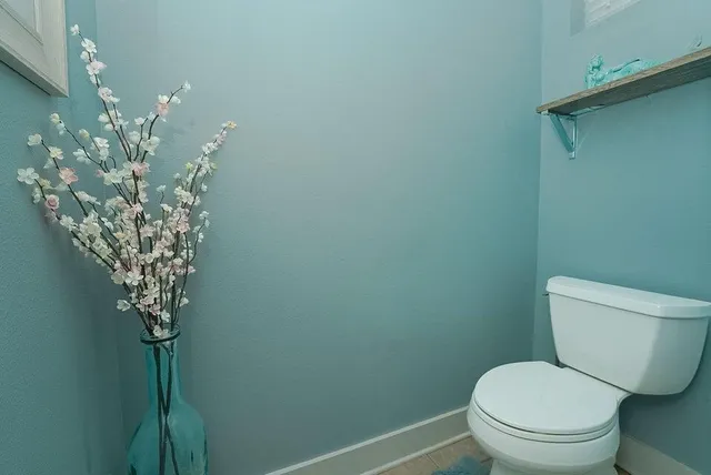 a room with a bed and a painting on the wall