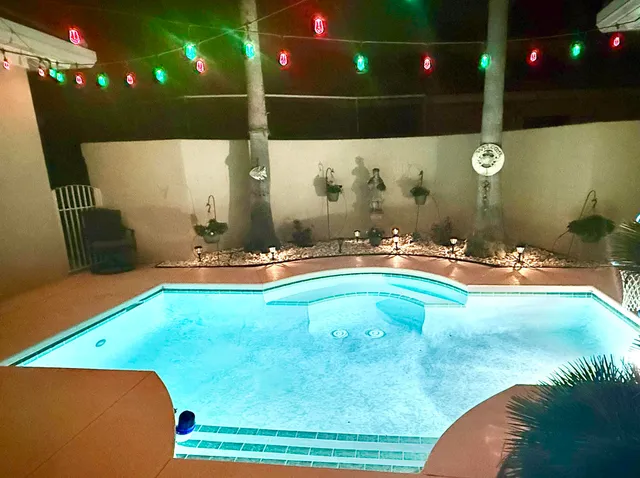 a view of a swimming pool with an outdoor seating