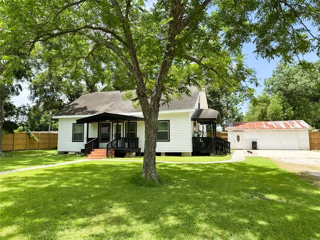 a view of a house with a yard and sitting area