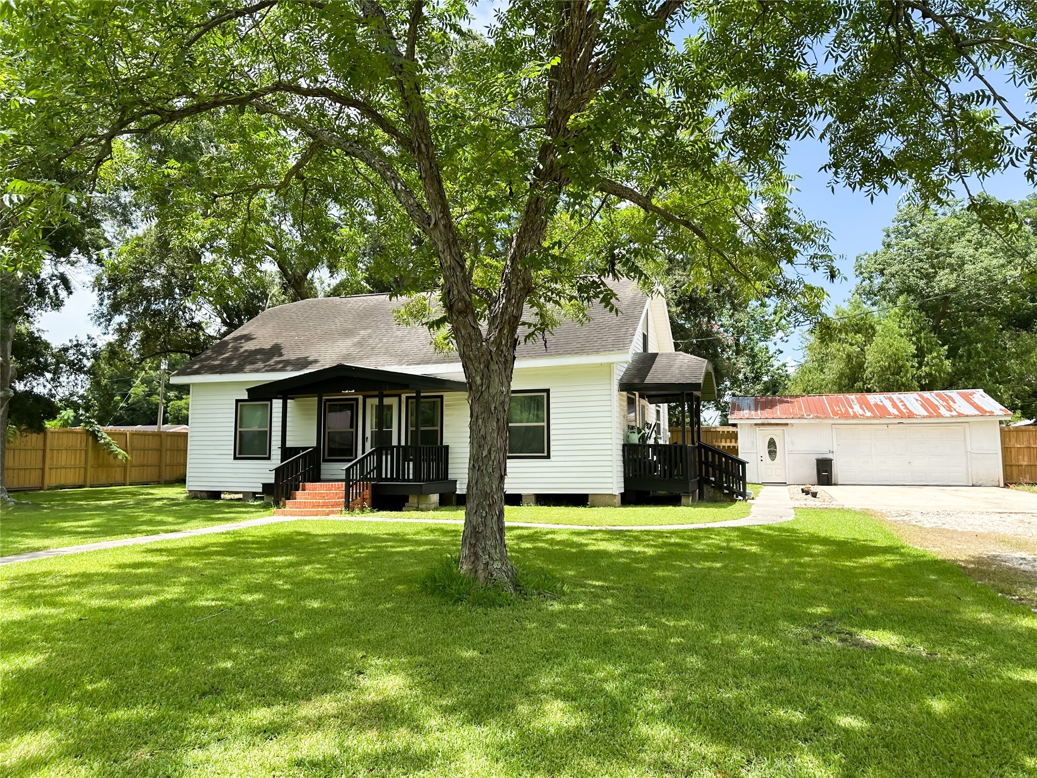 a view of a house with a yard and sitting area